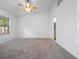 Neutral carpeted bedroom with ceiling fan and natural light at 6042 Brookhill Cir, Orlando, FL 32810