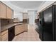 Kitchen features ample cabinet space, black appliances, tile flooring, and a sink with views to yard at 6042 Brookhill Cir, Orlando, FL 32810