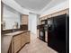 Kitchen features ample cabinet space, black appliances, and tile flooring at 6042 Brookhill Cir, Orlando, FL 32810