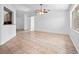 Bright living room featuring wood-look flooring, ceiling fan, and natural light at 6042 Brookhill Cir, Orlando, FL 32810