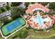 Aerial view of community pool and tennis court at a condo complex at 625 Pavia Loop, Lake Mary, FL 32746