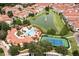 Aerial shot of community amenities, featuring a pool, tennis courts, and a pond at 625 Pavia Loop, Lake Mary, FL 32746