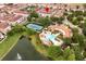 A high-angle view of community pool, tennis courts, and nearby pond at 625 Pavia Loop, Lake Mary, FL 32746