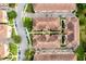 Aerial perspective of a condo complex featuring tidy lawns, mature trees, and designated parking at 625 Pavia Loop, Lake Mary, FL 32746