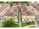 Aerial view of condos with tile roofs, mature trees, and landscaped common areas at 625 Pavia Loop, Lake Mary, FL 32746