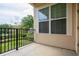 View from outdoor balcony with decorative railing overlooking manicured green landscape at 625 Pavia Loop, Lake Mary, FL 32746