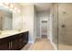 Bathroom featuring double vanity, walk-in closet, and glass shower doors at 625 Pavia Loop, Lake Mary, FL 32746