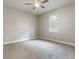 This bedroom has neutral walls, a ceiling fan with a light, wall trim, and a window with blinds at 625 Pavia Loop, Lake Mary, FL 32746