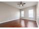Spacious bedroom with natural light, hardwood floors and a ceiling fan for optimal comfort and relaxation at 625 Pavia Loop, Lake Mary, FL 32746