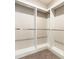 Bright walk-in closet with custom built-in shelving and carpeting at 625 Pavia Loop, Lake Mary, FL 32746