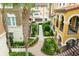 Beautiful condo courtyard featuring lush landscaping, brick walkways, and well-maintained building exteriors at 625 Pavia Loop, Lake Mary, FL 32746