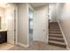 Hallway with neutral walls, carpet, bathroom with dark cabinet, and staircase with a window providing natural light at 625 Pavia Loop, Lake Mary, FL 32746