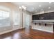 Bright eat-in kitchen featuring stainless steel appliances and a stylish granite countertop bar at 625 Pavia Loop, Lake Mary, FL 32746