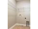 This laundry room features tiled floors, white walls, white shelving, and washer/dryer hookups at 625 Pavia Loop, Lake Mary, FL 32746