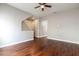 A clean living room offers hardwood floors, neutral paint, and an open floorplan with access to the stairway at 625 Pavia Loop, Lake Mary, FL 32746