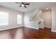 Bright living room featuring hardwood floors, a ceiling fan, and stairway to the upper level at 625 Pavia Loop, Lake Mary, FL 32746