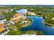 Scenic aerial view of the community buildings surrounded by lakes, trees, and lush landscaping in a serene setting at 636 San Augusto Dr, Kissimmee, FL 34759
