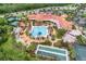 Aerial view of a community center with a pool, tennis courts, and lush landscaping at 636 San Augusto Dr, Kissimmee, FL 34759