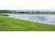 Scenic backyard view with pond and green grass in a beautiful neighborhood on a sunny day at 636 San Augusto Dr, Kissimmee, FL 34759