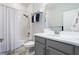 Well-lit bathroom with white subway tile shower and gray vanity, including a towel rack at 636 San Augusto Dr, Kissimmee, FL 34759