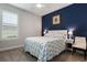 This bedroom has a blue accent wall with a queen bed and windows with plantation shutters at 636 San Augusto Dr, Kissimmee, FL 34759