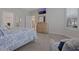 Serene bedroom showcases a dresser with a mirror and TV and the view of another living area at 636 San Augusto Dr, Kissimmee, FL 34759
