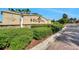 Community entrance sign with lush landscaping and clear blue skies at 636 San Augusto Dr, Kissimmee, FL 34759