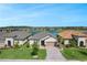 Charming single-story home with a brick driveway and well-manicured lawn near a serene lake at 636 San Augusto Dr, Kissimmee, FL 34759