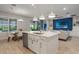 Bright, open kitchen with island, stainless appliances, and adjacent dining and living areas at 636 San Augusto Dr, Kissimmee, FL 34759