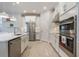 Bright kitchen featuring stainless steel appliances, quartz countertops, and ample storage space at 636 San Augusto Dr, Kissimmee, FL 34759