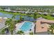 Community pool with spa, surrounded by palm trees and comfortable lounge chairs at 636 San Augusto Dr, Kissimmee, FL 34759