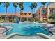 Beautiful community pool area with palm trees and comfortable seating, perfect for relaxation at 636 San Augusto Dr, Kissimmee, FL 34759