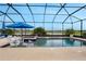 Relaxing screened-in pool area with comfortable seating and a serene view of the lake at 636 San Augusto Dr, Kissimmee, FL 34759