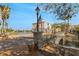 Charming street view with a stone bridge, American flags, and well-maintained landscaping at 636 San Augusto Dr, Kissimmee, FL 34759