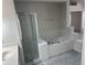 Bright bathroom featuring a shower, and bathtub with tile surround at 6625 Cherry Grove Cir, Orlando, FL 32809