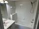 Clean bathroom featuring a bathtub with shower and a vanity, designed for relaxation and functionality at 6625 Cherry Grove Cir, Orlando, FL 32809