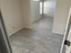 This is an empty bedroom with light gray tile floors and light colored walls at 6625 Cherry Grove Cir, Orlando, FL 32809