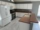 Bright kitchen with white cabinets, stainless steel appliances, and a breakfast bar, perfect for entertaining at 6625 Cherry Grove Cir, Orlando, FL 32809