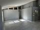Spacious living room with large windows, high ceilings, neutral gray paint, and tile floors, ready for your personal touch at 6625 Cherry Grove Cir, Orlando, FL 32809