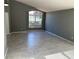 Cozy living room bathed in natural light, features large windows, tile flooring, and a serene ambiance at 6625 Cherry Grove Cir, Orlando, FL 32809