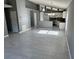 Open living space showcasing the kitchen with stainless steel appliances, dining area, and tile flooring at 6625 Cherry Grove Cir, Orlando, FL 32809
