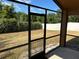 View from a screened in patio showing a green and natural back yard with a fence at 6625 Cherry Grove Cir, Orlando, FL 32809