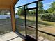 View from a screened in patio showing a natural back yard with a fence at 6625 Cherry Grove Cir, Orlando, FL 32809