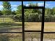 View from a screened in patio showing a green and natural back yard at 6625 Cherry Grove Cir, Orlando, FL 32809