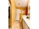 Bathroom with walk-in closet, vanity, and warm yellow walls at 6704 Westlake Blvd, Orlando, FL 32810