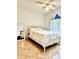 Bedroom with a white bed frame, ceiling fan, and large window providing natural light at 6704 Westlake Blvd, Orlando, FL 32810
