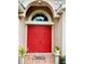 Inviting front entrance featuring a vibrant red double door with an arched window at 6704 Westlake Blvd, Orlando, FL 32810