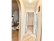 Neutral hallway with tile floors and arched doorways connecting living spaces at 6704 Westlake Blvd, Orlando, FL 32810