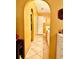 Hallway leading to bathroom with yellow walls and tiled floors at 6704 Westlake Blvd, Orlando, FL 32810