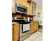 Well-lit kitchen featuring stainless steel appliances and wood cabinets at 6704 Westlake Blvd, Orlando, FL 32810